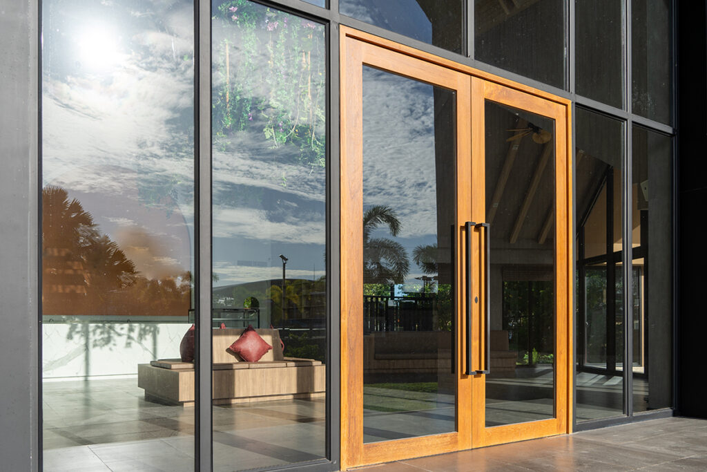 Glass door entrance to a large apartment hotel, the material is